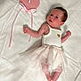 baby, infant, newborn, tutu, white_clothing, pink_sign, heart_shape, lying_down, bed_sheet, curious_expression, small_hands, small_feet, cute, soft_lighting, portrait, one_month, ribbon, pink_and_white, skin, person