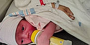 Jordan joined the competition — help win amazing prizes! baby, bed, blanket, bottle, clothing, comfort, cute, face, feeding, hand, hat, hospital, infant, lying, newborn, person, rest, skin, sleepwear, sleeve