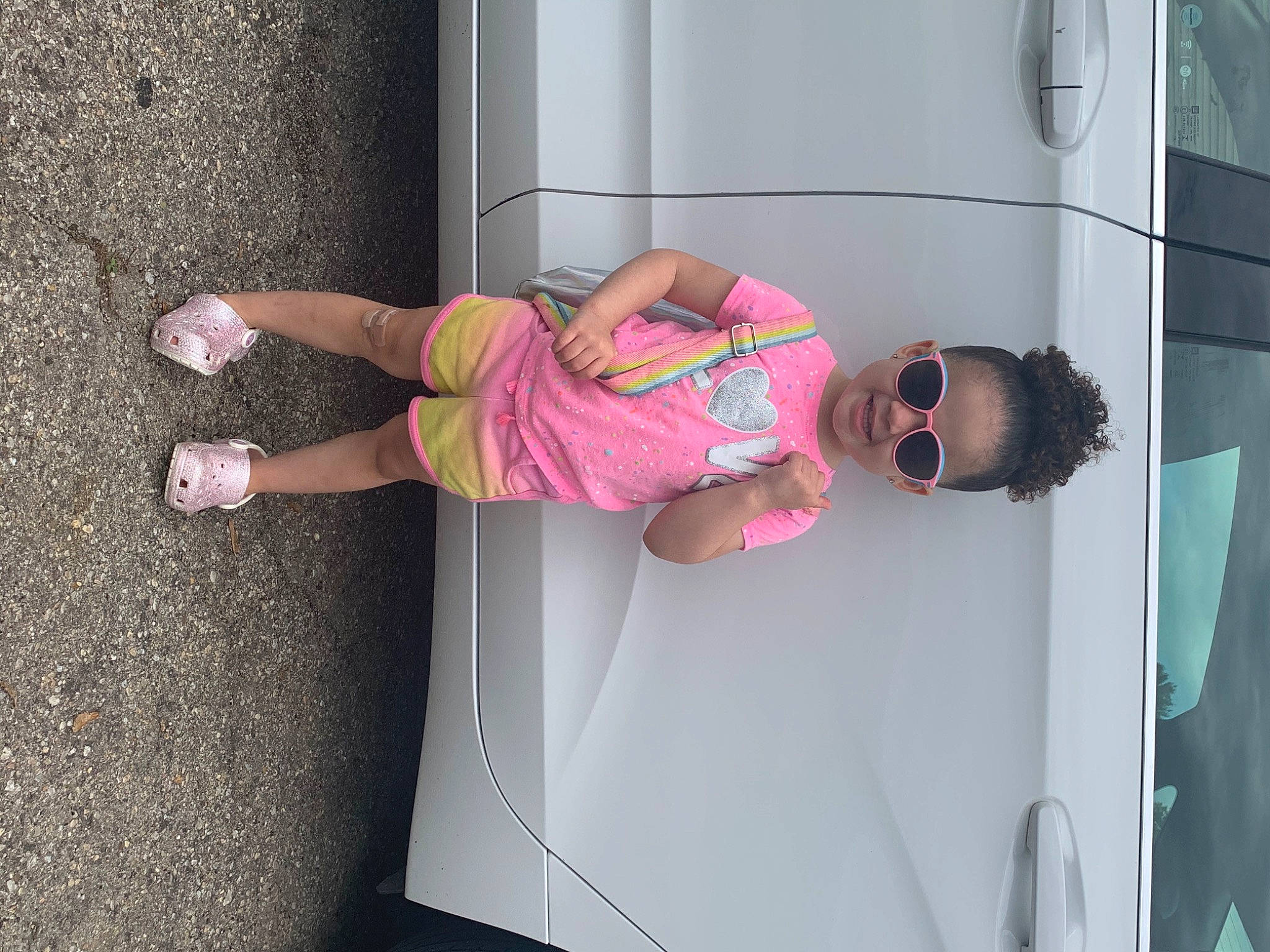 Malia joined the competition — help win amazing prizes! automotive_design, automotive_exterior, eyewear, fun, goggles, hat, human_leg, knee, leisure, magenta, person, pink, recreation, sneakers, street_fashion, sunglasses, thigh, tire, vehicle, vehicle_door