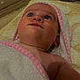 Elsie-Mae is registered to the contest to win money with this photo: baby, child, towel, blanket, face, skin, blue_eyes, eyelashes, droplet, floor, rug, pink, white, texture, closeup, portrait, infant, looking_up, wrapped, soft