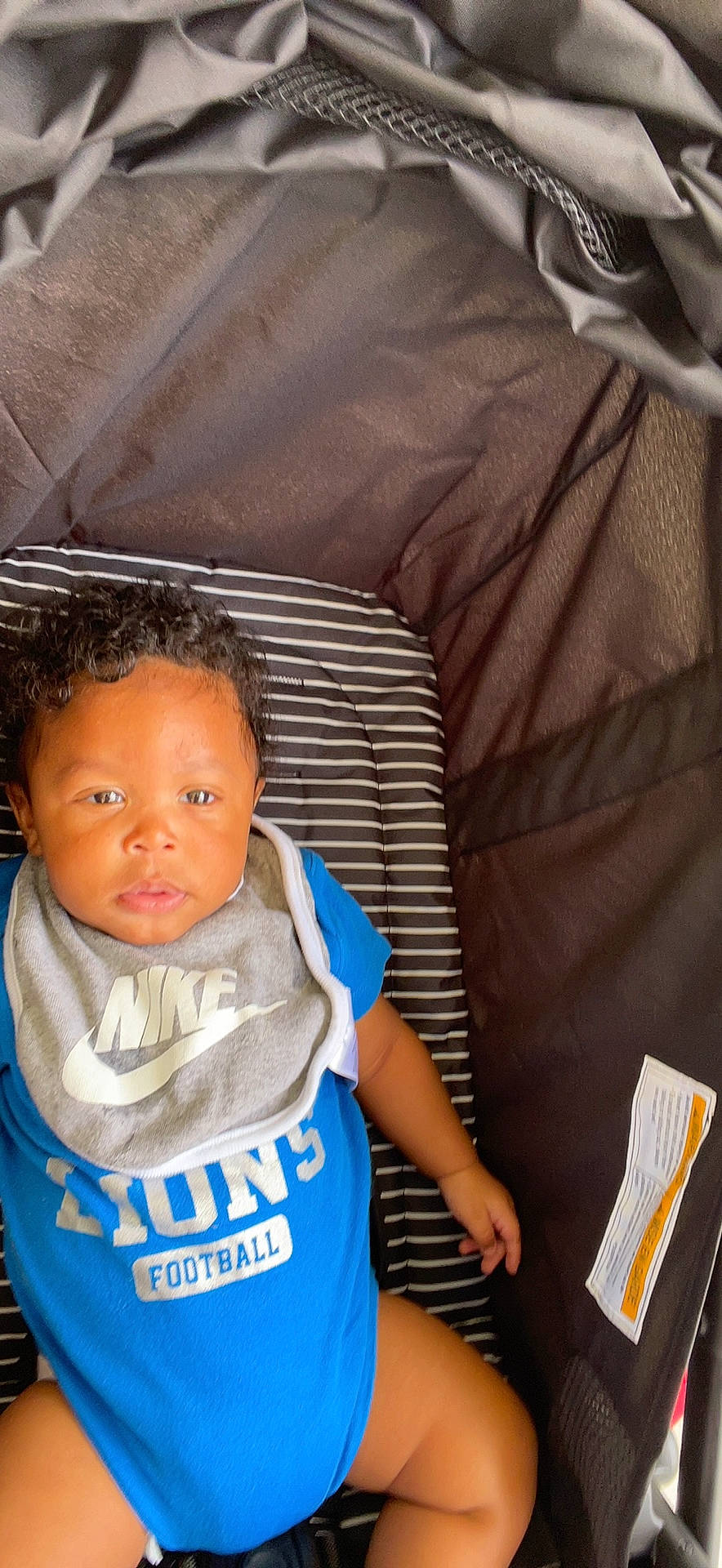 Lawrence is registered to the contest to win money with this photo: baby, baby_products, baby_toddler_clothing, cheek, child, chin, comfort, elbow, electric_blue, face, fun, happy, head, mouth, nose, person, sitting, sleeve, t_shirt, toddler