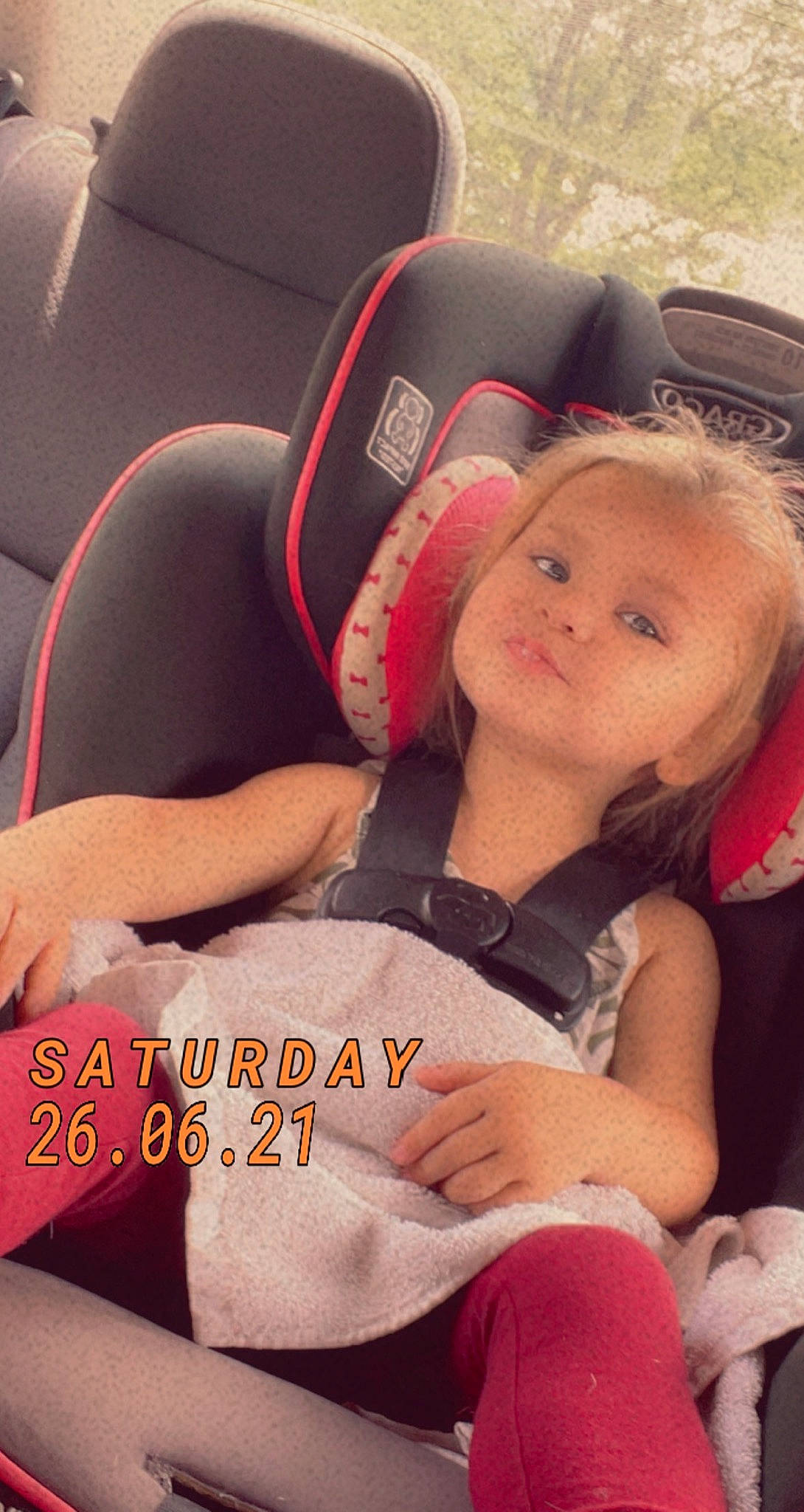 Adley is registered to the contest to win money with this photo: baby_carriage, car_seat, comfort, cool, face, happy, head_restraint, human_body, knee, lap, long_hair, mouth, person, selfie, shoulder, smile, sportswear, steering_wheel, thigh, toddler