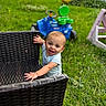 baby, backyard, blue_clothing, child, cute, daylight, grass, greenery, happy, infant, lawn, nature, outdoor, person, playtime, portrait, smiling, summer, toy_car, wicker_chair