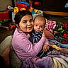 Daniel joined the competition — help win amazing prizes! child, baby, hugging, blanket, toy, living_room, floor, couch, smile, striped_clothing, purple_blanket, red_toy, carpet, person, indoor, affection, family, comfort, young_child, infant