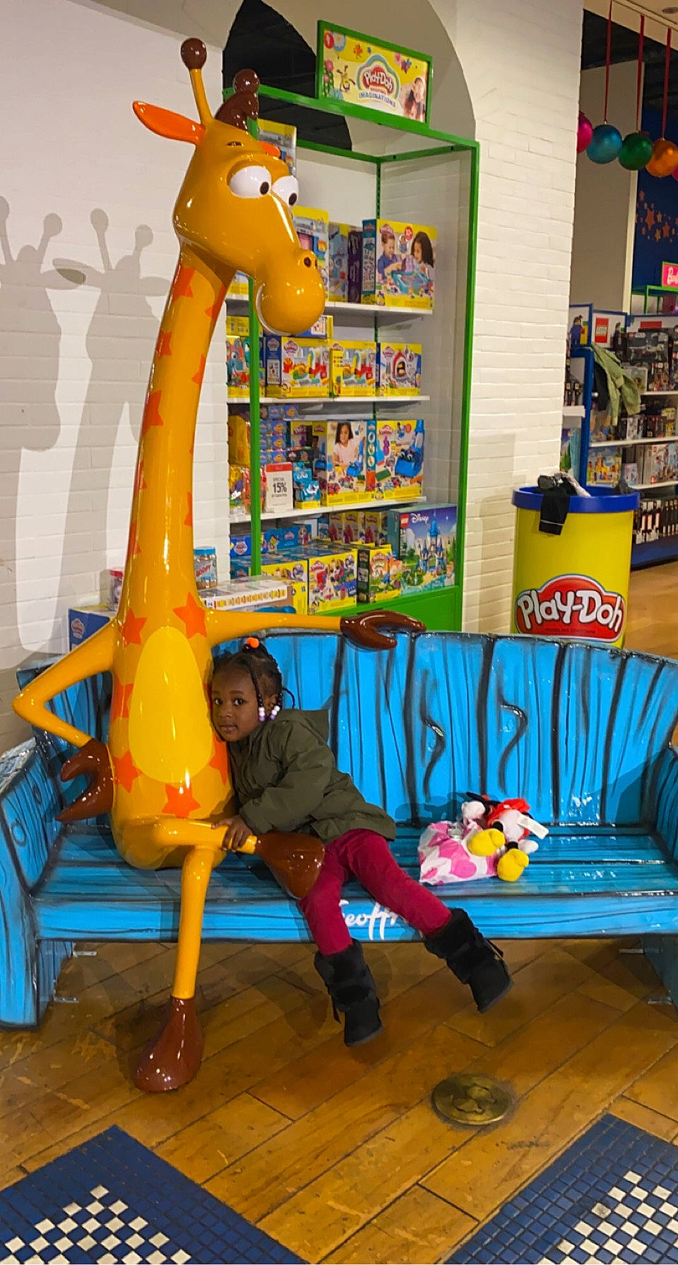 Niyah is registered to the contest to win money with this photo: art, blue, child, flooring, fun, green, interior_design, leisure, orange, person, photograph, play, recreation, room, shelf, snapshot, stuffed_toy, toy, vertebrate, visual_arts