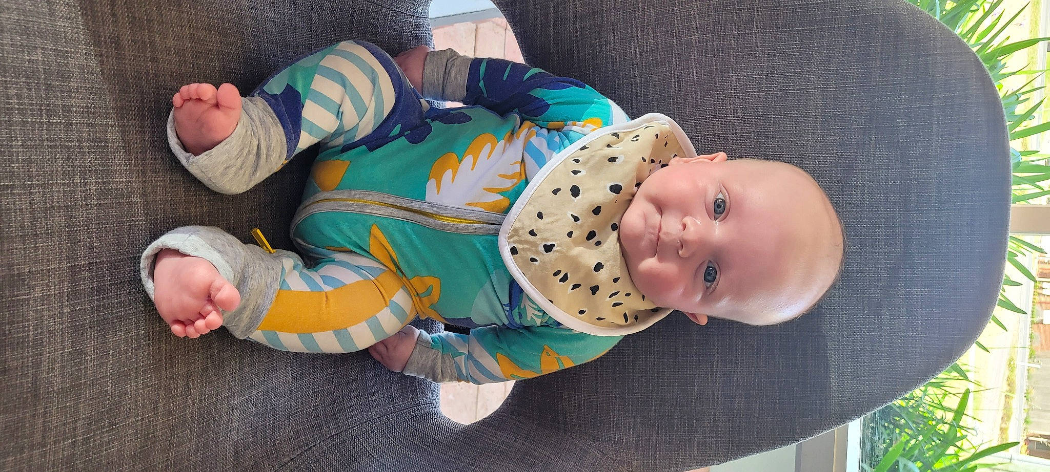 Charlie is registered to the contest to win money with this photo: baby, baby_products, baby_toddler_clothing, child, comfort, foot, fun, lap, pattern, person, product, sitting, sleeve, smile, sock, thumb, toddler, wrist