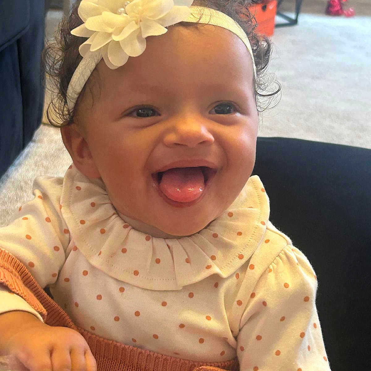 Ocean-Ray joined the competition — help win amazing prizes! baby, carpet, child, curly_hair, cute, flower, furniture, hand, happy, headband, indoor, knitwear, person, plastic_bag, polka_dot, portrait, ruffled_collar, smiling, tongue_out, treats