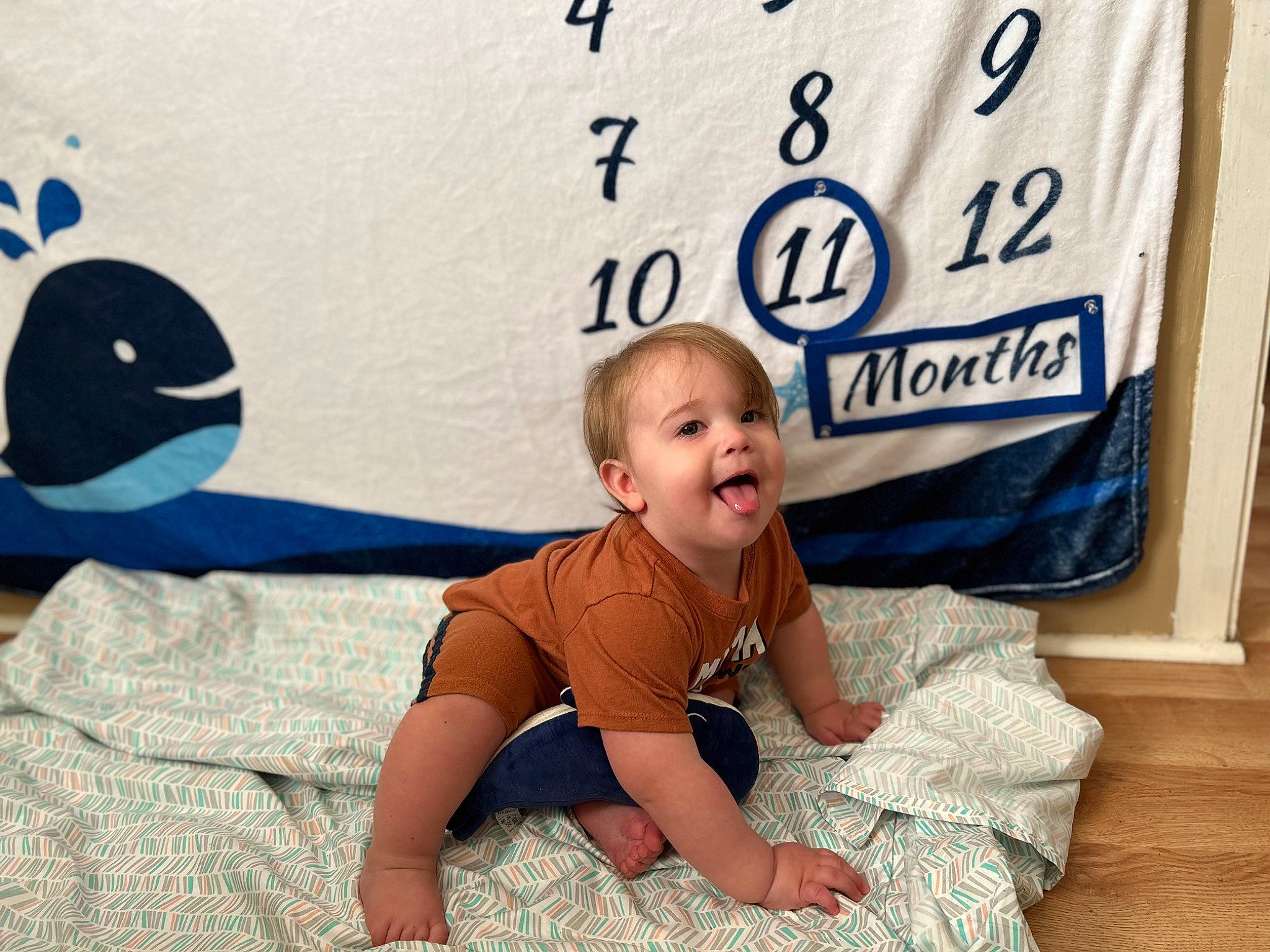 Dakota is registered to the contest to win money with this photo: baby, baby_toddler_clothing, child, flooring, font, fun, grass, happy, linens, logo, pattern, person, play, portrait_photography, product, sitting, sleeve, smile, t_shirt, toddler