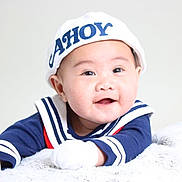 Julius Zane is registered to the contest to win money with this photo: adorable, baby, blanket, blue_clothing, child, closeup, cute, face, gloves, happy, indoor, infant, lying_down, portrait, sailor_hat, smiling, soft_texture, studio_lighting, white_hat, young_child
