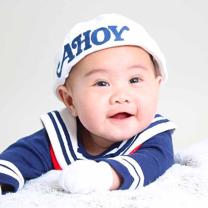 Julius Zane is registered to the contest to win money with this photo: adorable, baby, blanket, blue_clothing, child, closeup, cute, face, gloves, happy, indoor, infant, lying_down, portrait, sailor_hat, smiling, soft_texture, studio_lighting, white_hat, young_child
