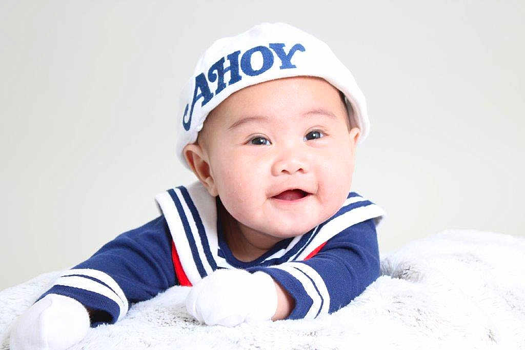 Julius Zane is registered to the contest to win money with this photo: adorable, baby, blanket, blue_clothing, child, closeup, cute, face, gloves, happy, indoor, infant, lying_down, portrait, sailor_hat, smiling, soft_texture, studio_lighting, white_hat, young_child