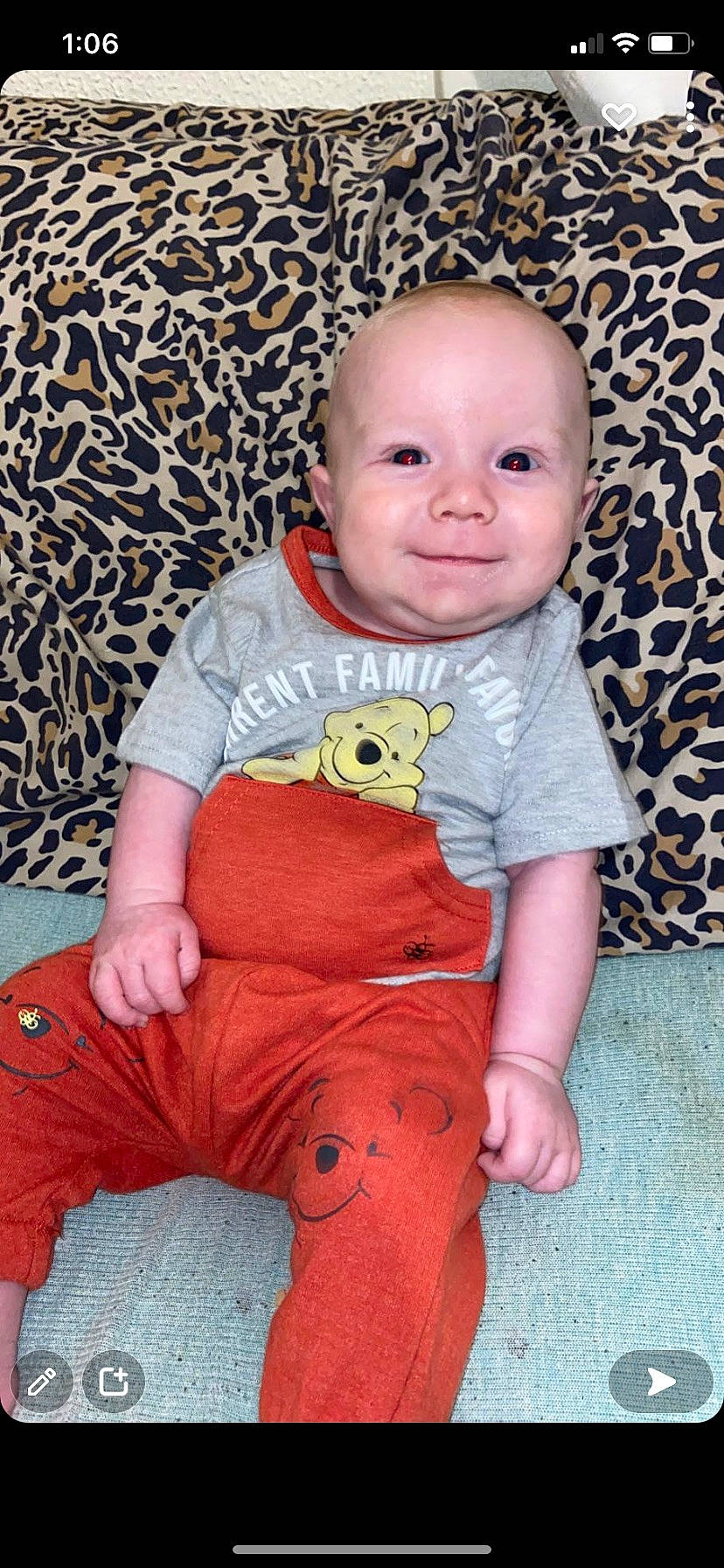 Legend is registered to the contest to win money with this photo: baby, baby_toddler_clothing, cheek, eye, face, facial_expression, floor, flooring, happy, head, human_body, joy, nose, person, pink, product, red, skin, sleeve, smile