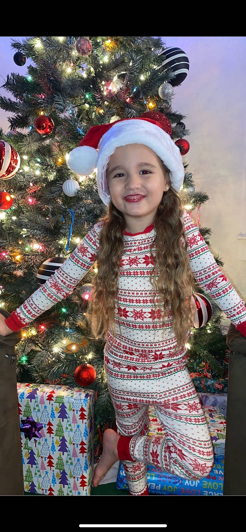 Amiyah joined the competition — help win amazing prizes! branch, christmas_decoration, christmas_ornament, christmas_tree, clothing, face, facial_expression, happy, head, headwear, holiday_ornament, human_body, joy, leaf, organ, outerwear, person, plant, sleeve, smile