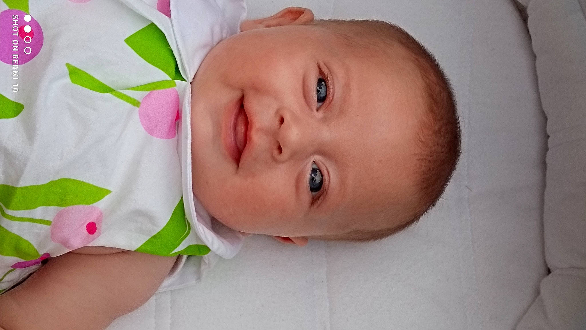 Joséphine a rejoint le concours — aidez-le/la à gagner de superbes lots ! baby, baby_products, baby_toddler_clothing, cheek, child, comfort, dress, eyelash, finger, hair_accessory, happy, lip, neck, nose, person, petal, portrait_photography, skin, sleeve, smile