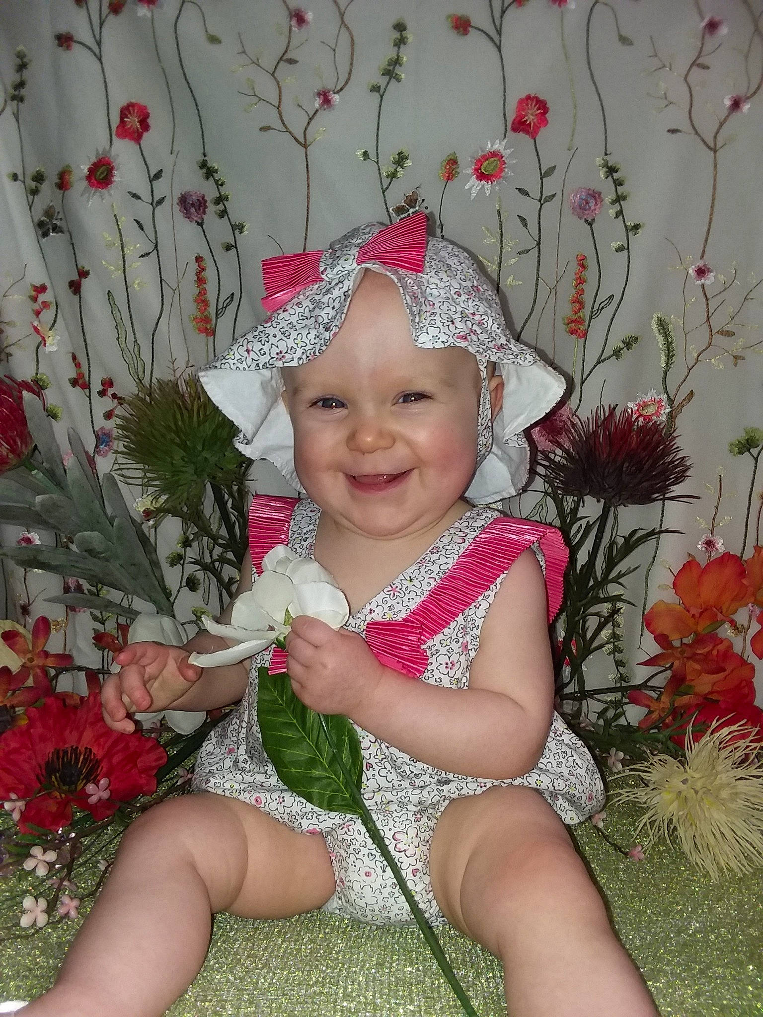 Wrenleigh is registered to the contest to win money with this photo: baby, child, flower, grass, happy, headgear, joy, person, pink, plant, smile, toddler