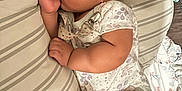 Braelynn joined the competition — help win amazing prizes! baby, sleeping, thumb_sucking, curly_hair, pillow, striped, floral, bedspread, infant, cute, peaceful, child, indoors, resting, soft_lighting, cozy, clothing, onesie, earring, skin