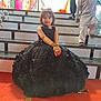 child, girl, boy, stairs, black_dress, henna, green_bangles, event, people, red_carpet, traditional_clothing, indoors, portrait, sitting, smile, decor, background, person, footwear, celebration