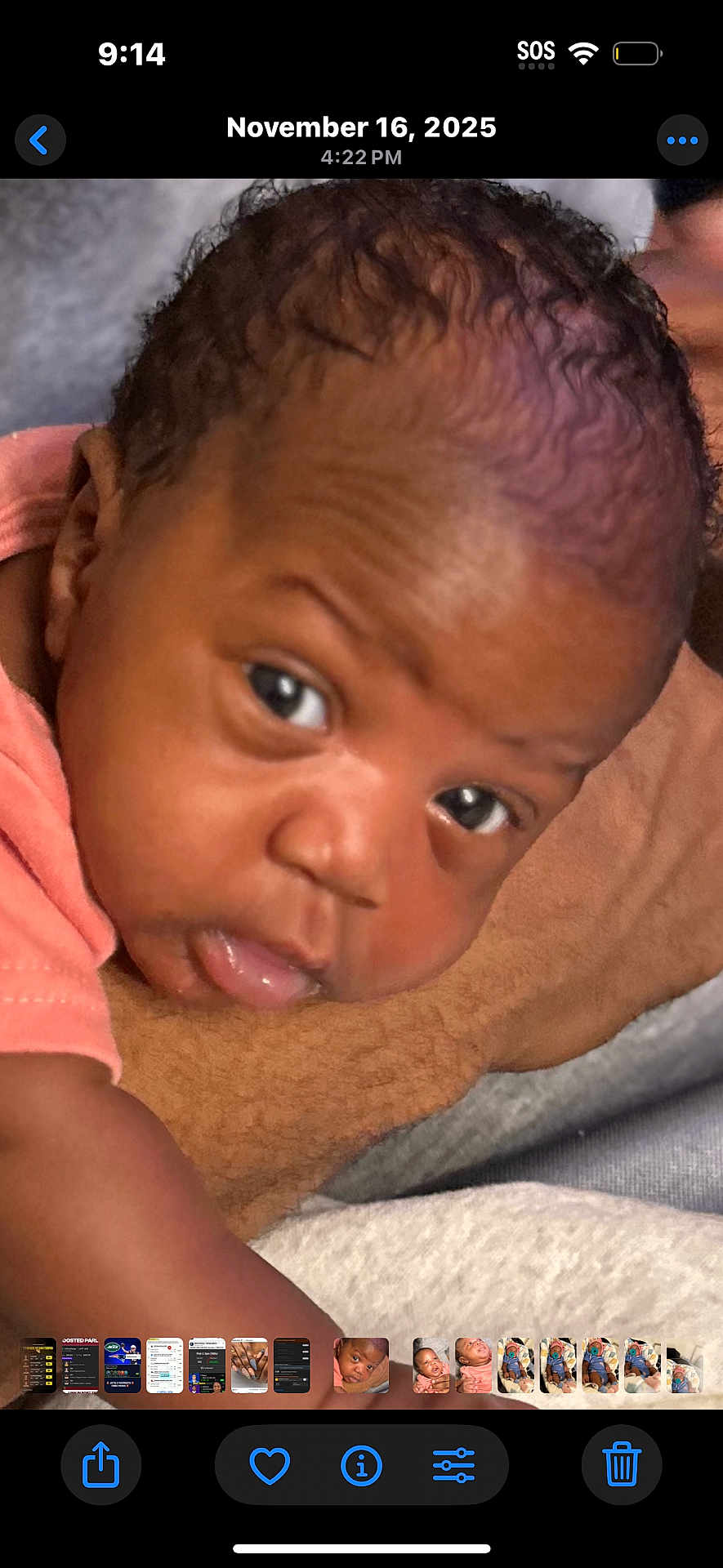 Azalea is registered to the contest to win money with this photo: baby, infant, close_up, face, eyes, skin, curly_hair, expression, resting, soft_surface, person, child, peach_clothing, portrait, indoors, newborn, cute, young, head, lying_down