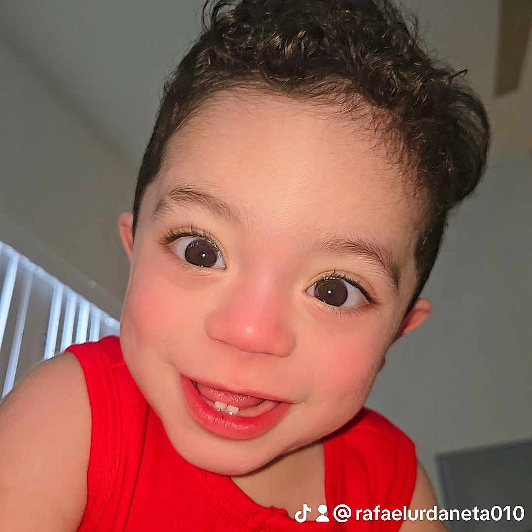 Axel Jared joined the competition — help win amazing prizes! child, toddler, smile, red_clothing, curly_hair, face, indoor, happy, close_up, eyes, teeth, skin, person, portrait, cute, head, baby, expression, young, background