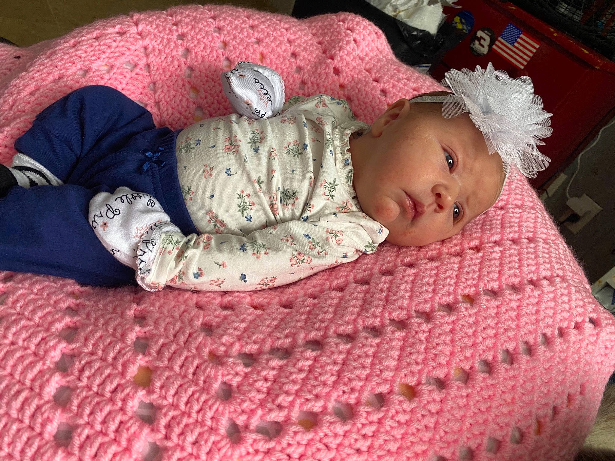 Paislee is registered to the contest to win money with this photo: baby, baby_products, baby_sleeping, baby_toddler_clothing, bedding, bedtime, cheek, child, comfort, flooring, linens, pattern, person, pink, red, sitting, skin, sleeve, toddler, wood