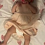 baby, bedtime, blanket, child, comfort, cute, dress, fabric, foot, hand, heart_pattern, indoors, infant, lying_down, pacifier, person, skin, sleepwear, soft_lighting, toddler