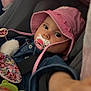 Lyla a rejoint le concours — aidez-le/la à gagner de superbes lots ! baby, blanket, car_seat, child, closeup, colorful, curious, cute, denim_jacket, headwear, indoor, infant, pacifier, pink_hat, portrait, reaching_hand, seatbelt, soft_toy, toy, young_child
