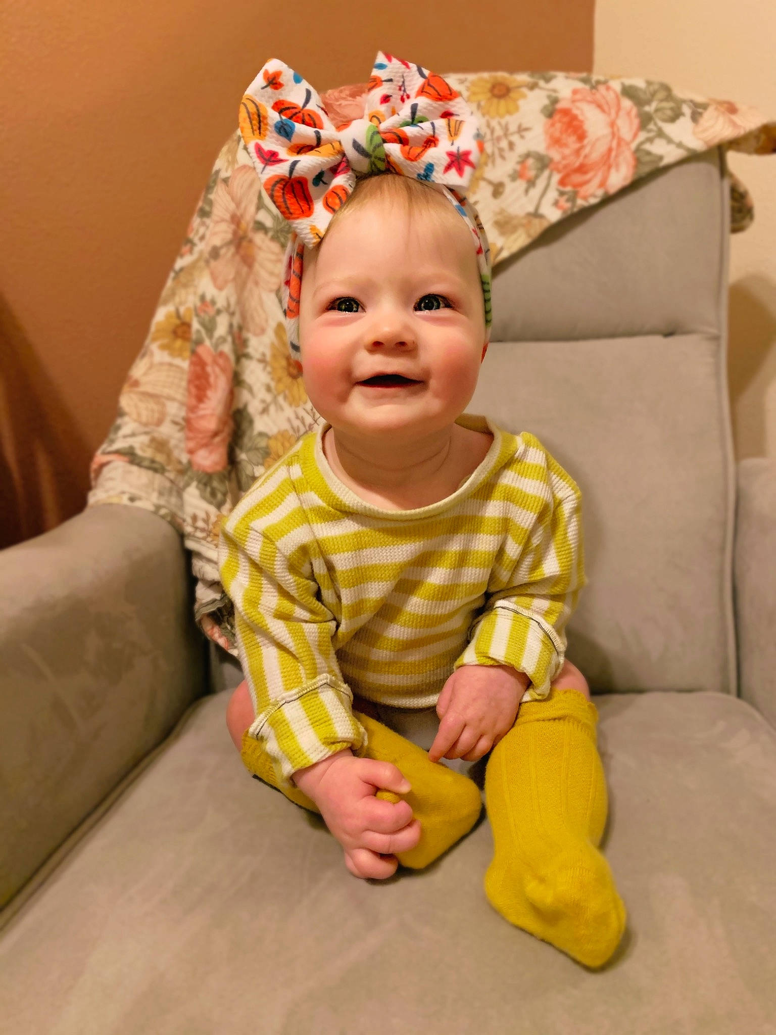 Addison joined the competition — help win amazing prizes! baby, baby_toddler_clothing, child, ear, hair_accessory, joy, person, sitting, sleeve, smile, toddler, yellow