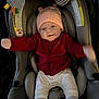 baby, car_seat, hat, jacket, socks, toy, infant, smile, clothing, seat, child, cute, striped, pink, red, white, gray, happy, indoors, warm