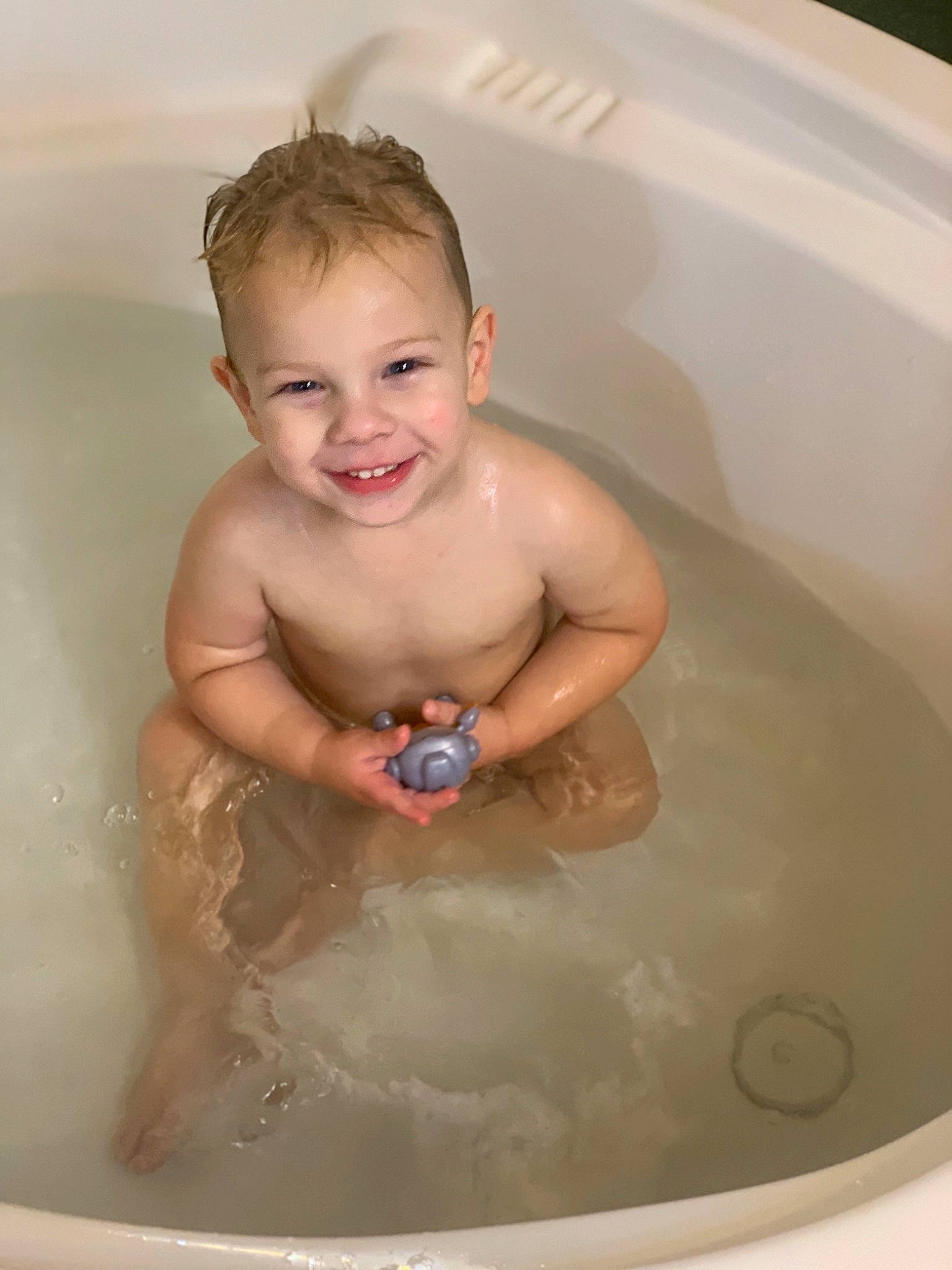 Ben is registered to the contest to win money with this photo: arm, baby, bathing, bathroom, bathtub, chest, eye, face, fluid, foam, hand, human_body, joy, leisure, liquid, muscle, person, plumbing, skin, smile