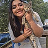 Mila joined the competition — help win amazing prizes! woman, cat, outdoor, smile, pet, animal, tree, car, daylight, portrait, happy, holding, casual_clothing, nature, tattoo, feline, person, greenery, sunlight, wooden_fence