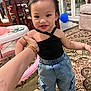 baby, balloon, bread, clothing, face, food, footwear, furniture, happy, head, indoors, jeans, pants, person, photography, portrait, shoe, sitting, smile, table