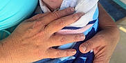 Oakley is registered to the contest to win money with this photo: adult, baby, blue, care, closeup, comfort, eyes, face, hands, holding, infant, newborn, outdoor, pattern, person, portrait, skin, towel, warmth, wrapped