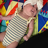 Oakley joined the competition — help win amazing prizes! baby, bow, cheeks, child, colorful_blanket, cute, geometric_pattern, happy, headband, indoors, infant, knitted_outfit, lying_down, playful, portrait, relaxed, small_hands, smiling, soft_skin, striped_clothing