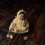 baby, child, costume, yellow, chick, fluffy, wooden_floor, bowl, smiling, cute, animal, pet, plush, sitting, face, portrait, indoor, small_chicks, happy, playful