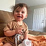 toddler, child, smile, happy, baby_bottle, pacifier, toy_story, woody, clothing, diaper, blanket, indoor, couch, hair, face, person, cute, living_room, furniture, infant