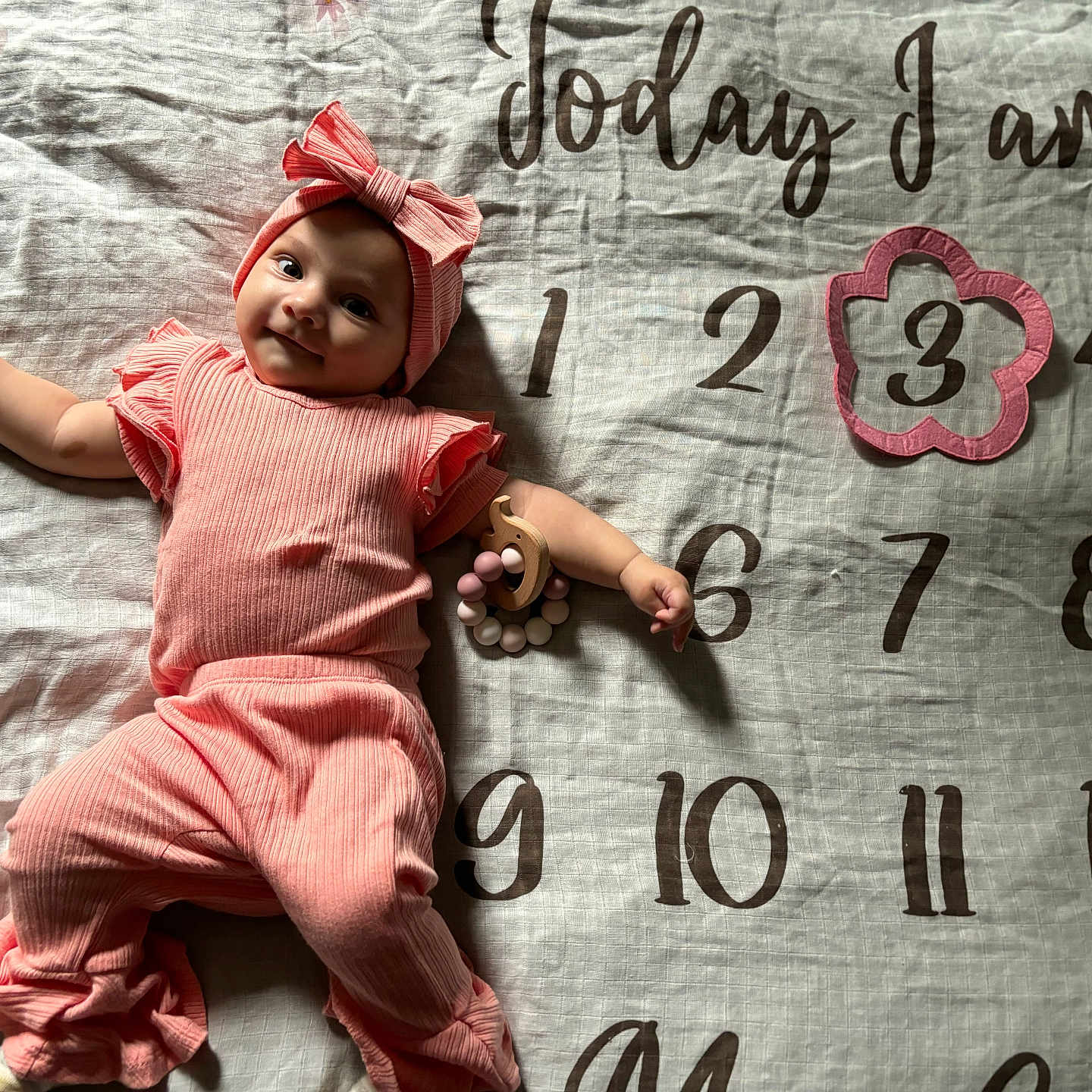 Naomi joined the competition — help win amazing prizes! baby, blanket, bodypart, bonnet, cap, clothing, dress, face, finger, hand, hat, head, homedecor, linen, person, photography, portrait, sitting, t_shirt, text