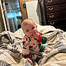 Peyton joined the competition — help win amazing prizes! baby, blanket, child, comfort, cozy, curious, dresser, face, furniture, hand, home, indoor, infant, pajamas, person, room, sitting, sleepwear, soft_lighting, wooden