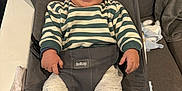 Tiago a rejoint le concours — aidez-le/la à gagner de superbes lots ! baby, smiling, striped_sweater, gray_chair, couch, pacifier, soft_toy, cozy_clothing, indoor, child, cute, infant, sitting, happy, comfortable, person, home, furniture, portrait, relaxed