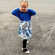 Angela a rejoint le concours — aidez-le/la à gagner de superbes lots ! child, girl, pose, blue_clothing, floral_skirt, black_tights, shoes, asphalt, sidewalk, car, chalk_markings, outdoor, playground, confident, smiling, young, fashion, hair_buns, earrings, street