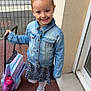 Angela participe au concours pour gagner de l'argent avec cette photo : child, girl, denim_jacket, skirt, backpack, sneakers, smile, outdoor, pavement, fence, door, building, happy, young, fashion, casual, standing, person, cute, ready