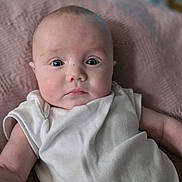 Arien joined the competition — help win amazing prizes! baby, infant, face, eyes, expression, clothing, blanket, texture, soft, comfort, skin, head, portrait, cute, young, person, indoors, laying, white, sleepwear