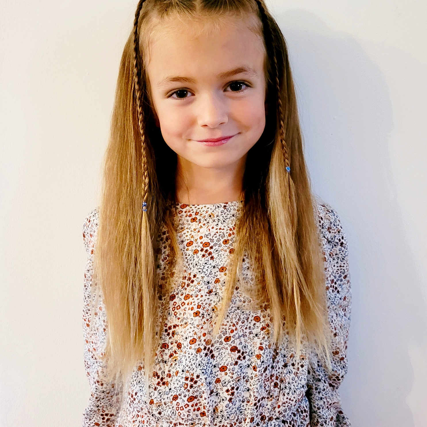 Iris participe au concours pour gagner de l'argent avec cette photo : blonde_hair, braids, casual, child, cute, fashion, floral_dress, girl, happy, indoor, innocence, light, long_hair, patterned_clothing, person, portrait, smile, standing, white_background, youth