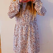 Iris participe au concours pour gagner de l'argent avec cette photo : child, girl, standing, heart_hands, braided_hair, dress, patterned_dress, boots, black_boots, indoor, tile_floor, wall, smiling, long_hair, cute, portrait, fashion, person, happy, posing