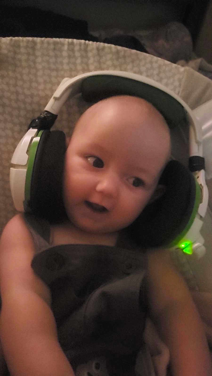 Scarlet joined the competition — help win amazing prizes! baby, headphones, child, infant, gaming, cute, portrait, expression, face, ear_cups, technology, indoor, closeup, young, person, wearing, listening, seat, soft_lighting, patterned_background
