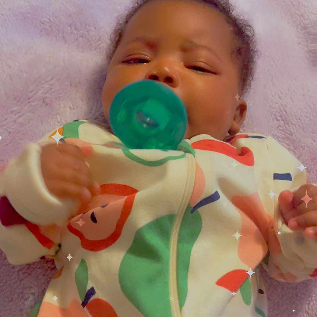 Torii joined the competition — help win amazing prizes! baby, pacifier, blanket, onesie, colorful, fruit_pattern, infant, sleepy, soft, cute, sparkles, indoors, child, portrait, hand, face, clothing, cozy, relaxed, lying_down