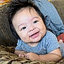 baby, infant, smile, happy, hair, spiky_hair, couch, cushion, gray_clothing, face, child, indoor, plant, home, portrait, cute, person, young_child, relaxed, comfort