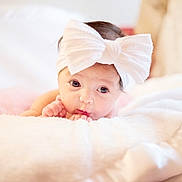 Scarlett is registered to the contest to win money with this photo: baby, infant, headband, bow, blanket, soft, cute, face, portrait, child, sleepwear, indoors, resting, newborn, closeup, expression, skin, tinyhands, cozy, pink