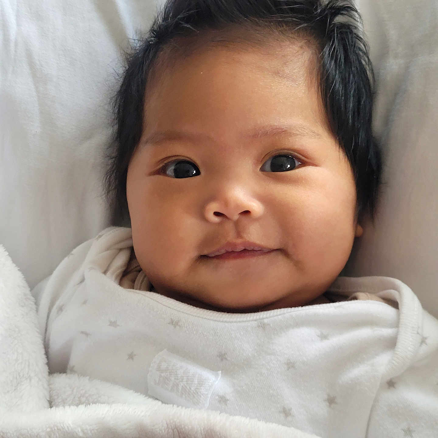 Ayla joined the competition — help win amazing prizes! baby, blanket, bodypart, clothing, ear, face, finger, frown, hand, happy, head, hoodie, mouth, newborn, person, photography, portrait, sad, smile, towel