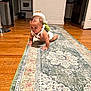 Isaiah joined the competition — help win amazing prizes! baby, crawling, turtle_backpack, rug, wooden_floor, kitchen, appliances, home_interior, child, infant, carpet, flooring, cute, indoor, person, crawling_baby, decor, appliance, toddler, backpack