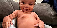 Isaiah is registered to the contest to win money with this photo: baby, child, smiling, diaper, seat, indoor, couch, furniture, person, skin, hand, arm, face, head, hair, dimples, comfort, relaxing, expression, living_room
